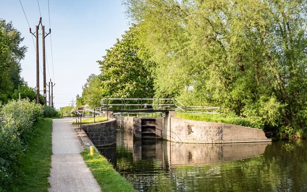 English canal lock and tow path, Lee Valley, England. A tow path and canal lock on the River Lee Navigation, near Cheshunt, north of London.