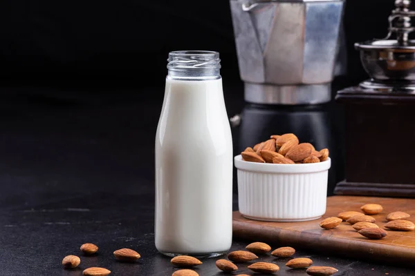 Close Up glass of Almond milk with Almond seeds. Almond milk in a glass with almonds