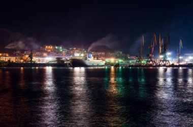 The ship enters port at night. Sakhalin. clipart