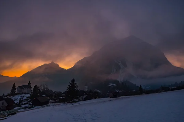 View from village Puergg to dramatic sunset over mountain Grimmi