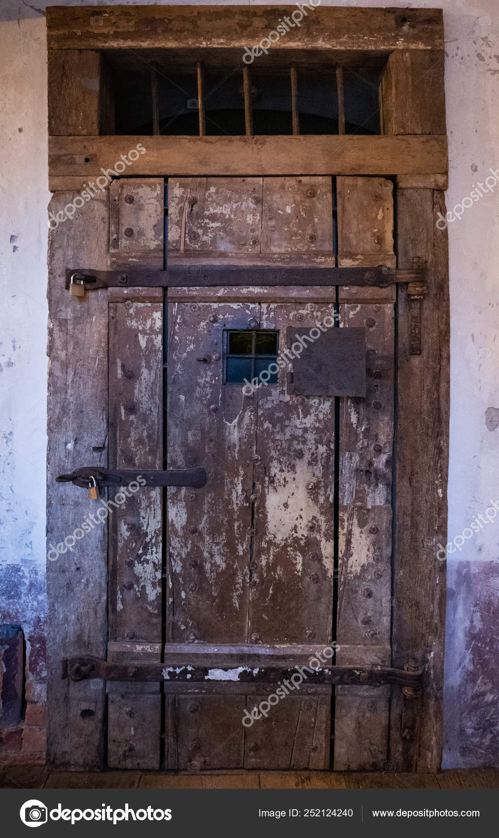 Old Wooden Door With Rusty Steel Door Fittings On Prison Stock