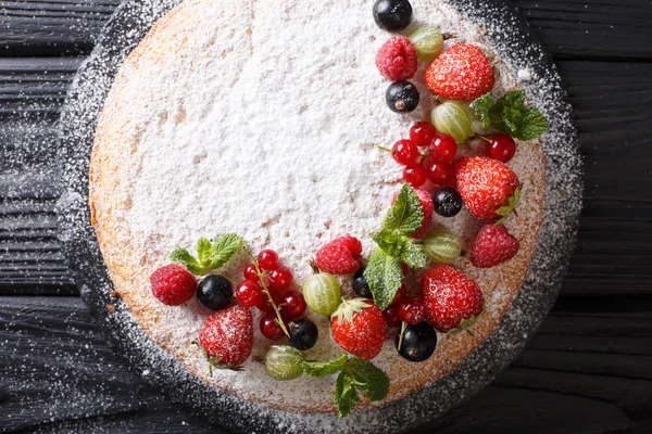 Victoria sandviç kek çilek, ahududu, Bektaşi, kuş üzümü ve nane closeup masanın üzerinde. Abov üzerinden yatay üstten görünüm