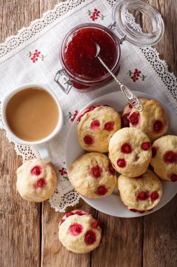Ülke stil çörekler çilek ile masaya İngilizce çay ve reçel yakın çekim ile servis edilir. Abov gelen dikey üstten görünüm