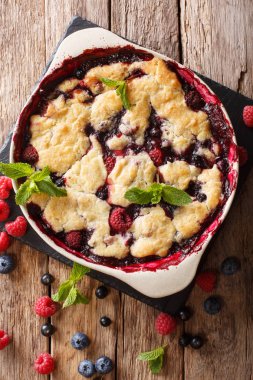 Pasta tatlı tart, ahududu, kuş üzümü ve yaban mersini yakın çekim bir masada pişirme için bir tabak içinde. abov gelen dikey üstten görünüm