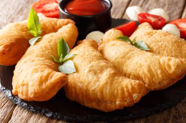 İtalyan kızarmış çörek panzerotti ahşap bir masa yakın çekim. Horizonta