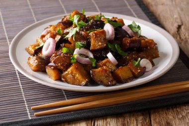 stir fried Szechuan eggplant  in spicy soy sauce with ginger, garlic, pepper, closeup on a plate. Horizonta clipart