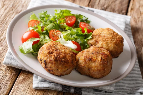 Tasty Danish pork minced meat patties in breading with fresh vegetable — Stock Photo, Image