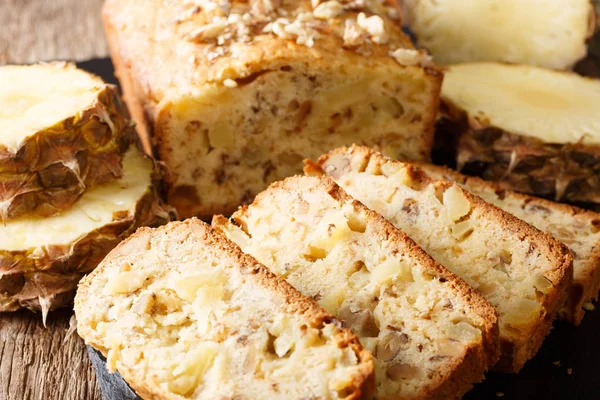 Delicious homemade pineapple bread with walnuts close-up on the table. horizonta