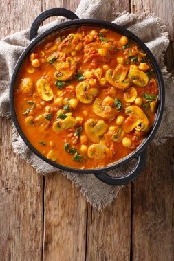 Mantar curry ile bir tavada masada ıspanak ve nohut yakın çekim. Abov gelen dikey üstten görünüm