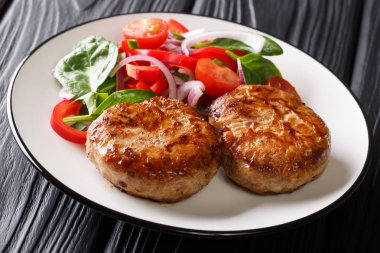 Bölümü Fransız kızarmış et topları crepinette ve masaya bir tabak taze sebze salatası yakın çekim. Horizonta