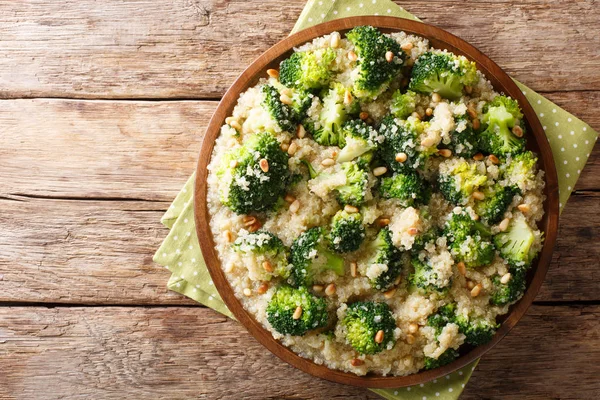 Broccoli salad with quinoa and pine nuts close-up on a plate. ho — Stock Photo, Image