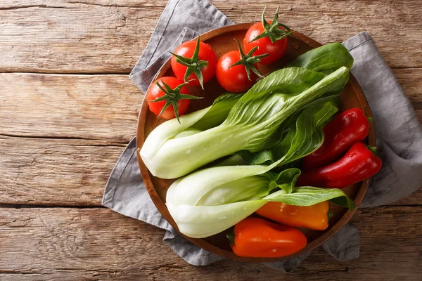 Fresh ingredients baby bok choy, tomatoes and peppers close-up o — Stock Photo, Image