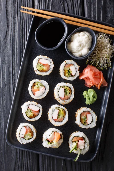 Uramaki rolls set served with sauces, soy sprouts, ginger and wa — Stock Photo, Image