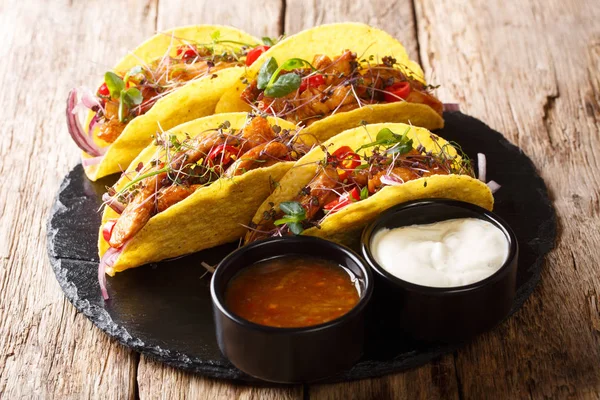 Mexican fast food tacos with glazed chicken, microgreen and vege