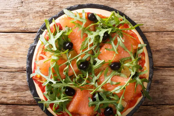 Delicious pizza with salted salmon, arugula, olives and cheese c — Stock Photo, Image