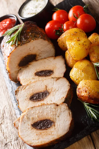 Carne di maiale al forno con prugne secche servita con patate giovani e salse clo — Foto Stock
