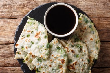 Chinese Scallions pancake also known as green onion pancake or c clipart