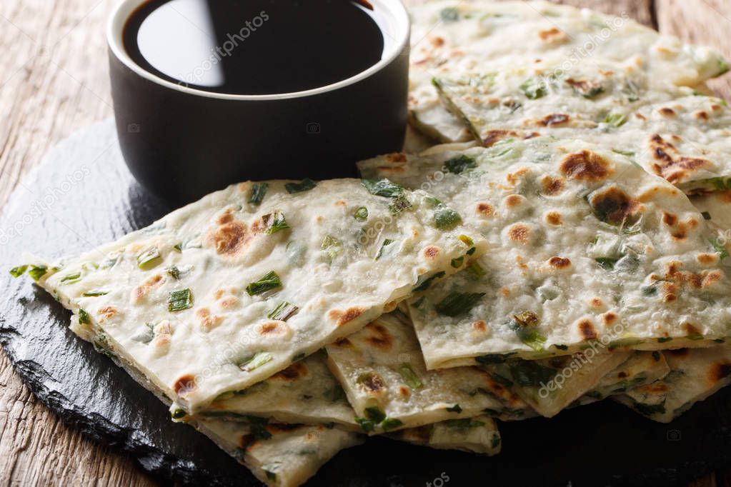 Chinese appetizer fried onion pancakes served with sauce close-u