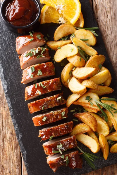 baked pork tenderloin with rosemary in honey-orange sauce served