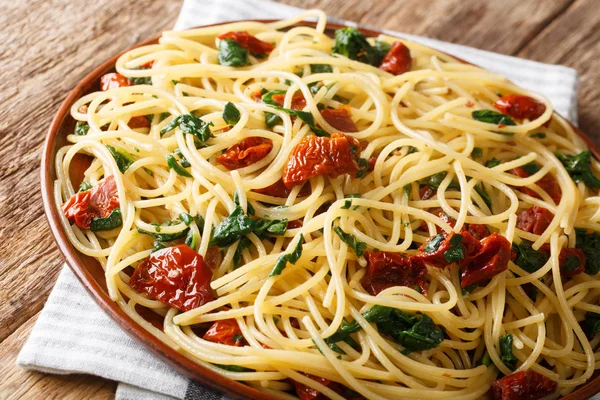 Bijgerecht van spaghetti met gedroogde tomaten, kaas en spinazie c — Stockfoto