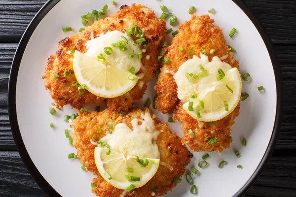 Serving romano chicken cutlet fried breaded with lemon and green