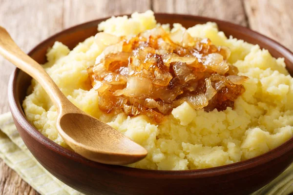 Simple food mashed potatoes with caramelized onions close-up on