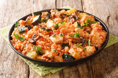 Tavuklu pilav, kabak ve mantar, domates, masada yakın plan otlar. yatay