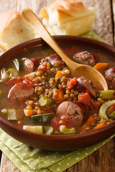 Homemade lentil soup with sausages and vegetables close-up in a plate on the table. vertica — Stock Image Homemade Lentil Soup Sausages Vegetables Close Plate Table Vertica Stock Image