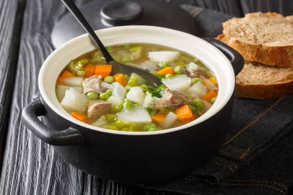 Traditional Scottish recipe Hairst Bree Hotch Potch soup close-up in a pot on the table. Horizonta — Stock Image Traditional Scottish Recipe Hairst Bree Hotch Potch Soup Close Pot Royalty Free Stock Photos