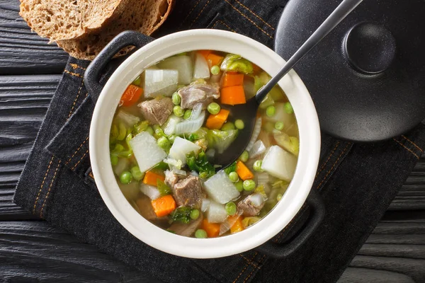 Hairst bree Lamb and summer vegetable soup close-up in a pot on the table. Horizontal top view from abov — Stock Image Hairst Bree Lamb Summer Vegetable Soup Close Pot Table Horizontal Royalty Free Stock Images