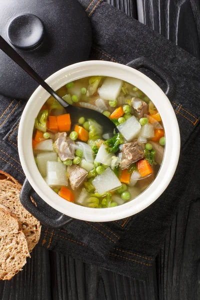 Tradtional Scottish Harvest Broth called Hotch Potch with lamb meat close-up in a pot on the table. Vertical top view from abov — Stock Image Tradtional Scottish Harvest Broth Called Hotch Potch Lamb Meat Close Stock Photo