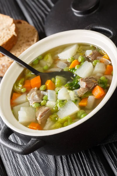 Tradtional Scottish Harvest Broth called Hotch Potch with lamb meat close-up in a pot on the table. Vertica — Stock Image Tradtional Scottish Harvest Broth Called Hotch Potch Lamb Meat Close Stock Picture