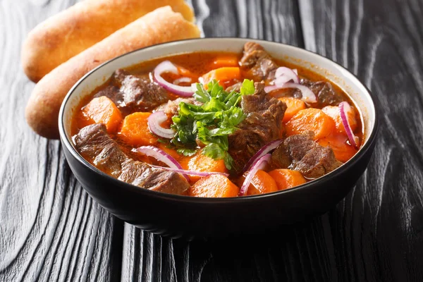 Bo kho is a delicious spicy beef stew dish, that is popular in Vietnam close-up in a bowl on the table. Horizonta
