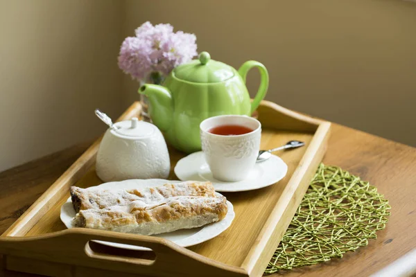 Afternoon tea concept: Cup of herbal linden tea, apple pie on white background. Flat lay