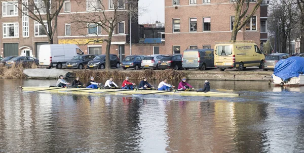 Eight people rowing in a baot — Stock Photo, Image