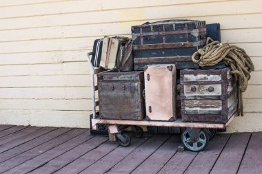 Vintage Luggage On Cart At Old Railroad Station clipart