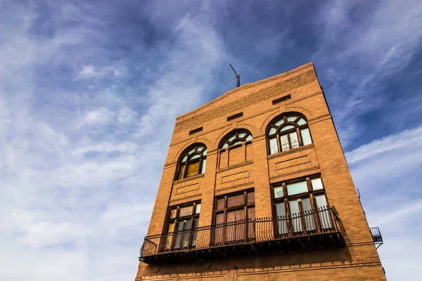 Vintage çok hikaye tuğla binası ile yukarıya pencere eşiği bindik