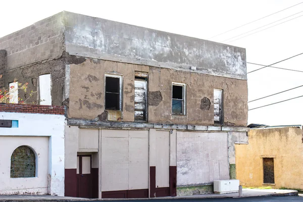 Distressed Commercial Storefront With Boarded Up Windows