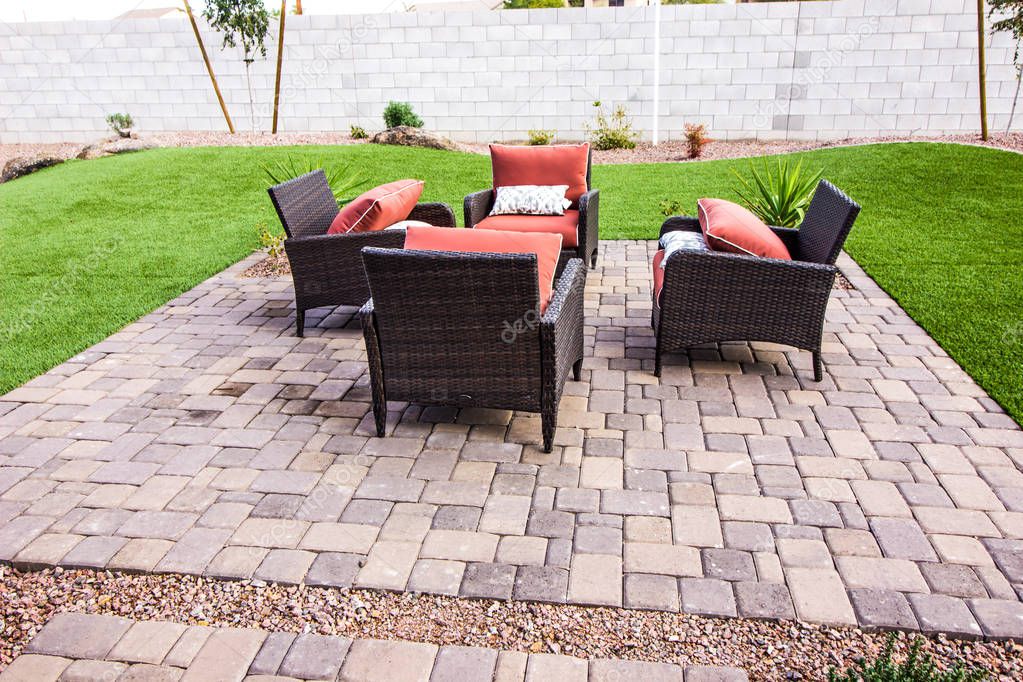 Four Wicker Chairs On Outdoor Patio