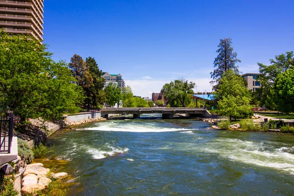 Rushing River Under Bridge In Downtown Area