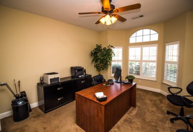 Office With Wooden Desk, Black File Cabinet And Computer clipart