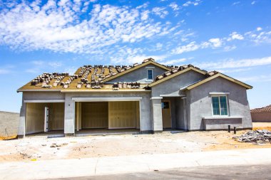 Brand New Stucco Home Under Construction With Three Car Garage clipart