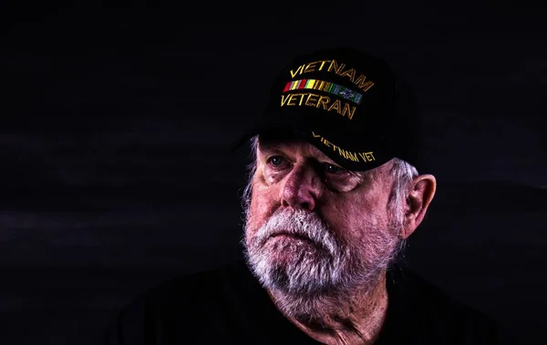 Old Vietnam Veteran With Blank Look On Weathered Face