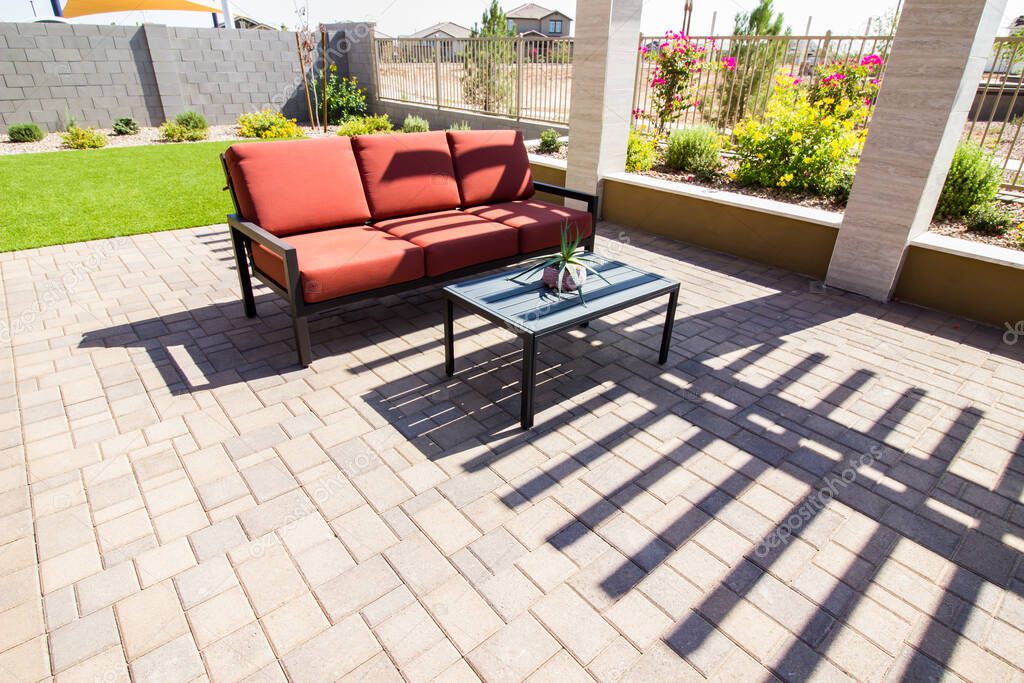 Rear Patio With Pavers, Coffee Table And Couch With Cushions