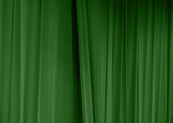 Details of a green curtain with vertical folds