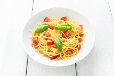 Tabak spagetti taze domates ve fesleğen yaprağı, Akdeniz yemekleri ile 