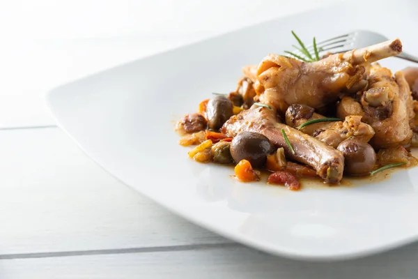 Dish of stewed rabbit meat with delicious olive and carrot sauce ...