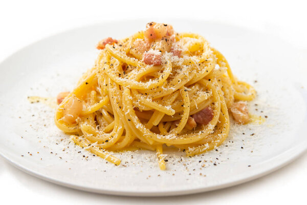 Spaghetti alla Carbonara, typical recipe of italian pasta with guanciale, eggs and pecorino cheese 