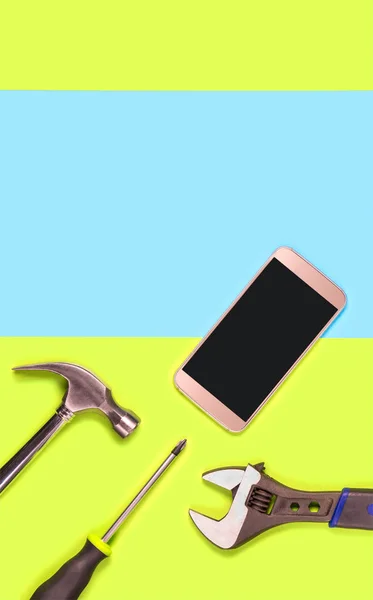 Vertical mobile phone repair background or template for smartphone fixing company\'s advertisement in print. Blank empty copy space for text and content. Cellphone and tools on green and blue texture.