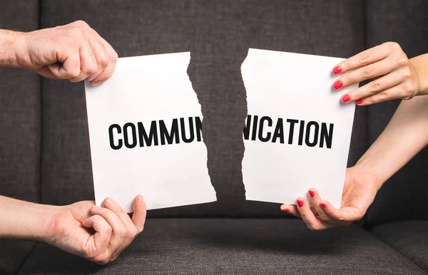 Communication problem in relationship. Marital difficulties. Couple fighting. Man and woman holding ripped paper.